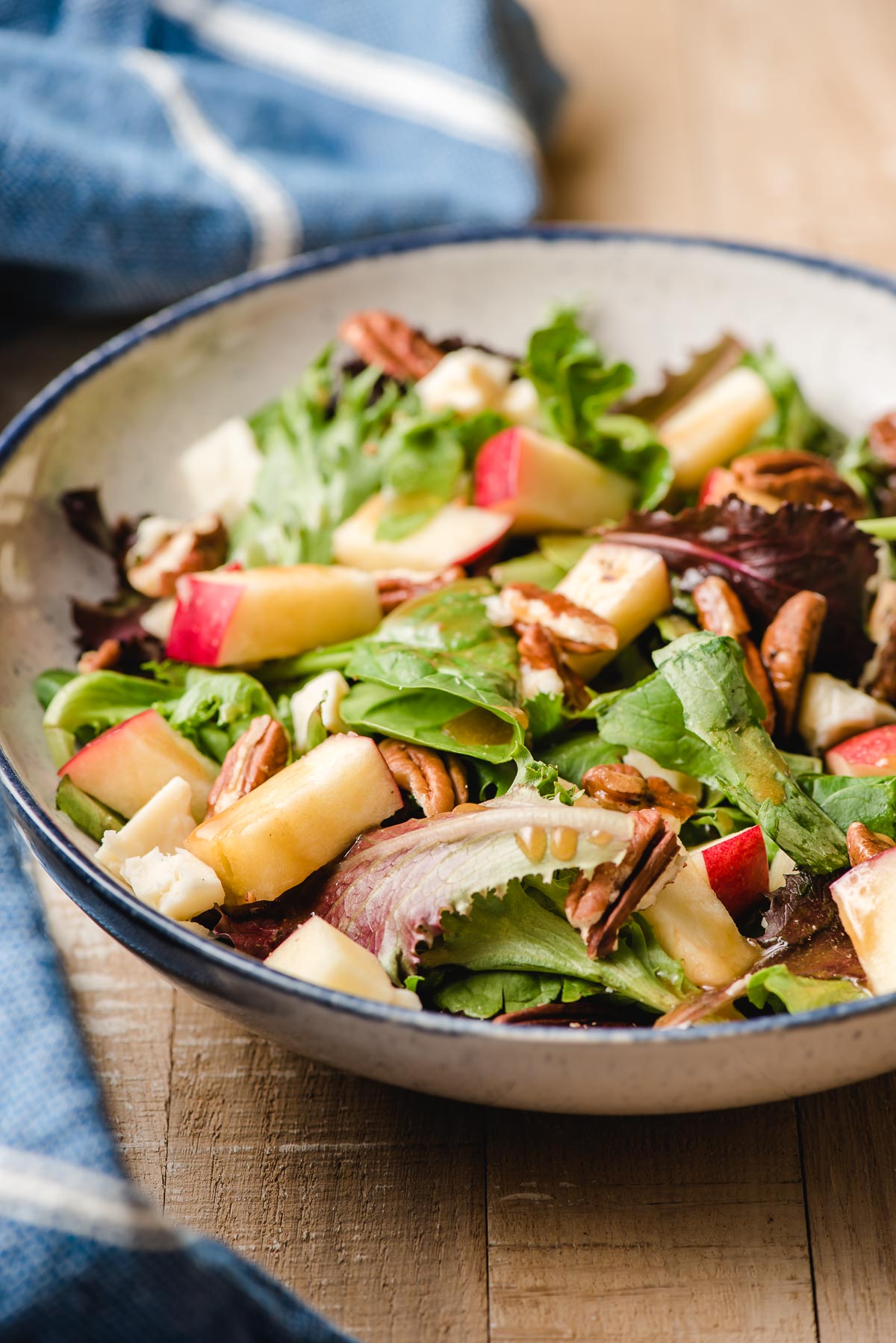 Salad with apples, goat cheese, chicken, and maple dressing.