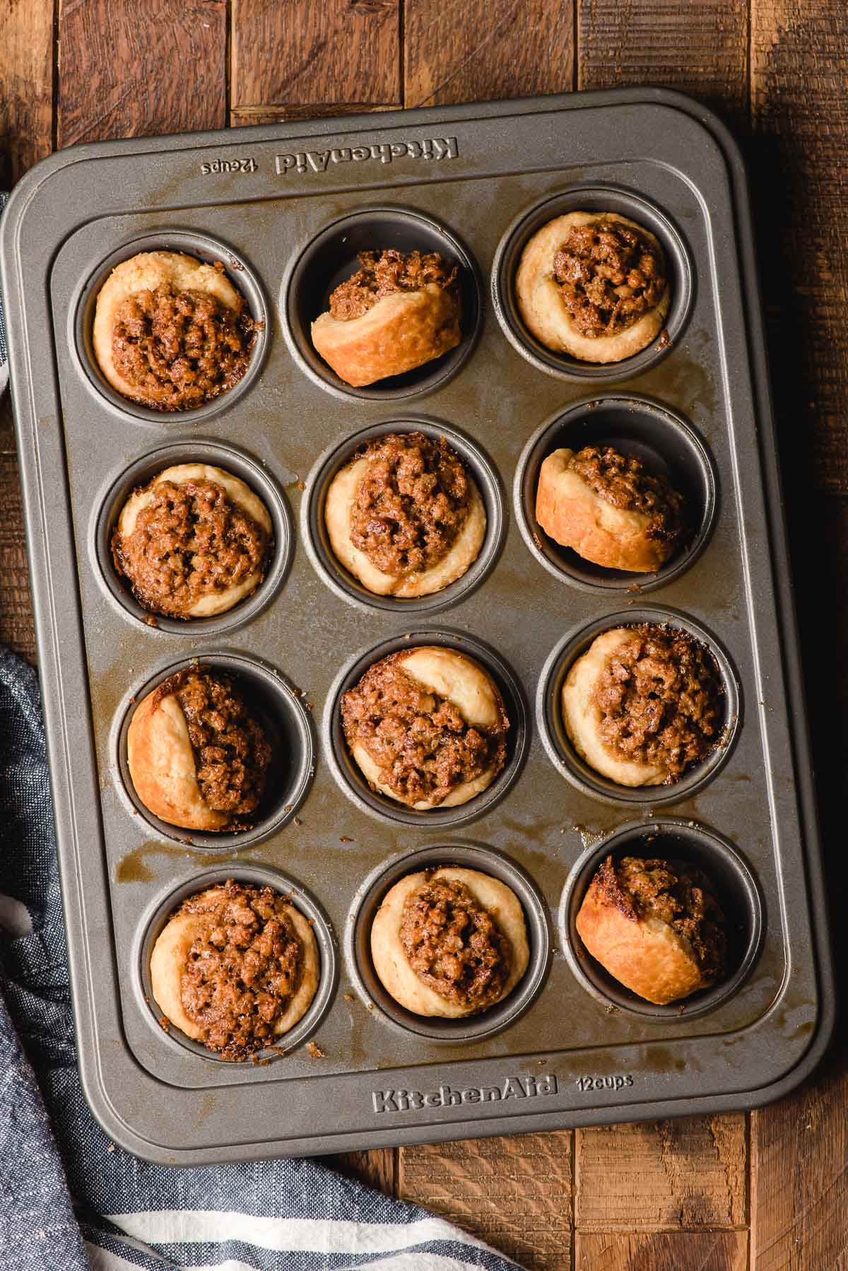 Mini pecan pies in a mini muffin tray.
