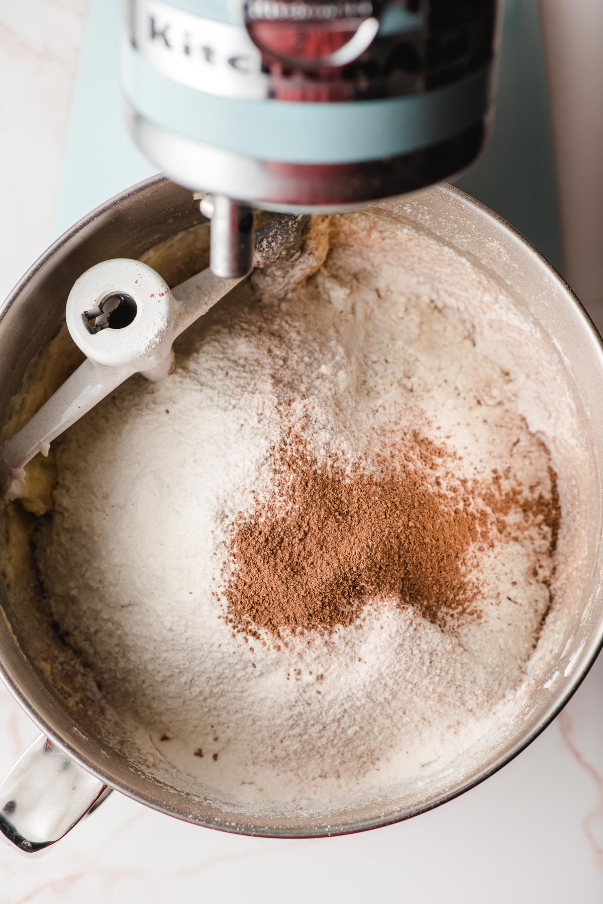 Flour, cocoa, and other dry ingredients being mixed into whoopie pie batter.