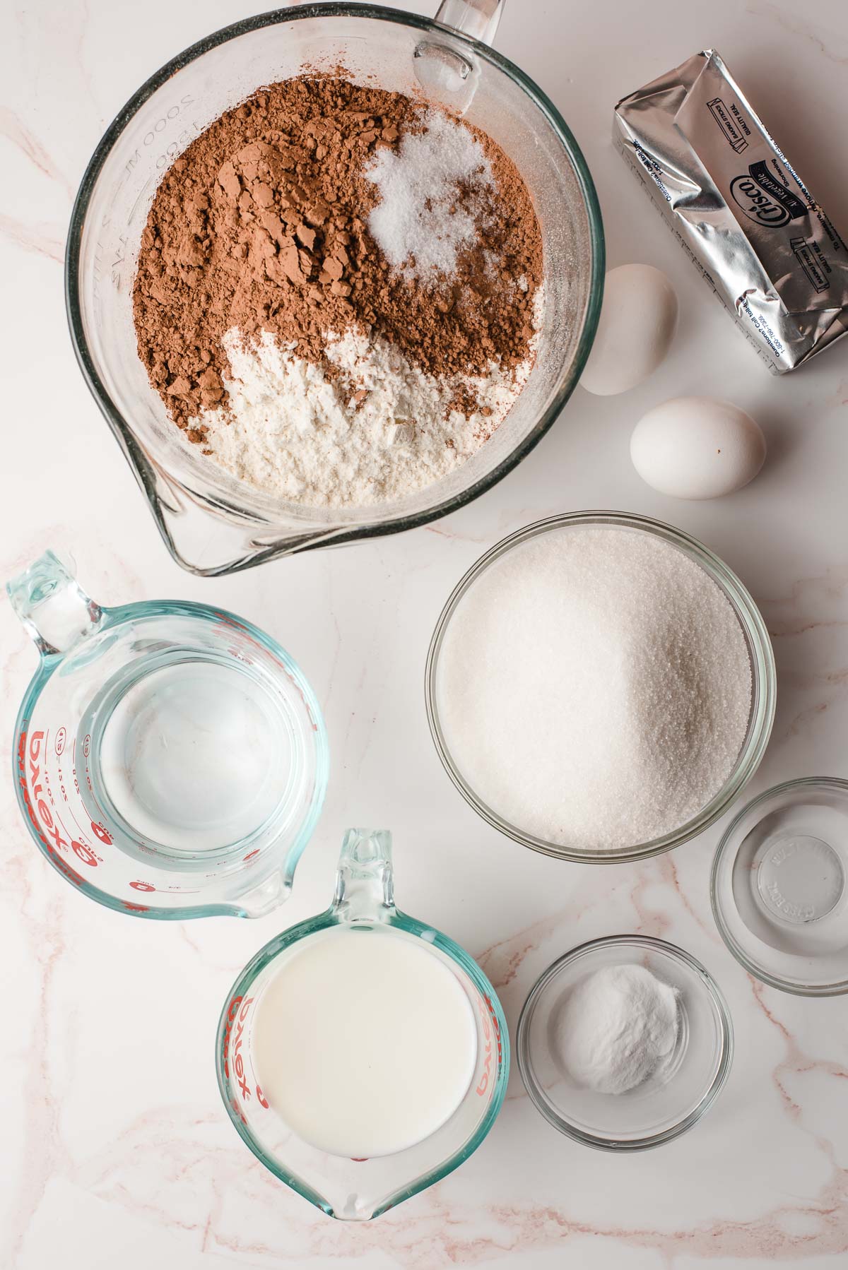 Ingredients for the chocolate whoopie pie cookies in glass bowls.
