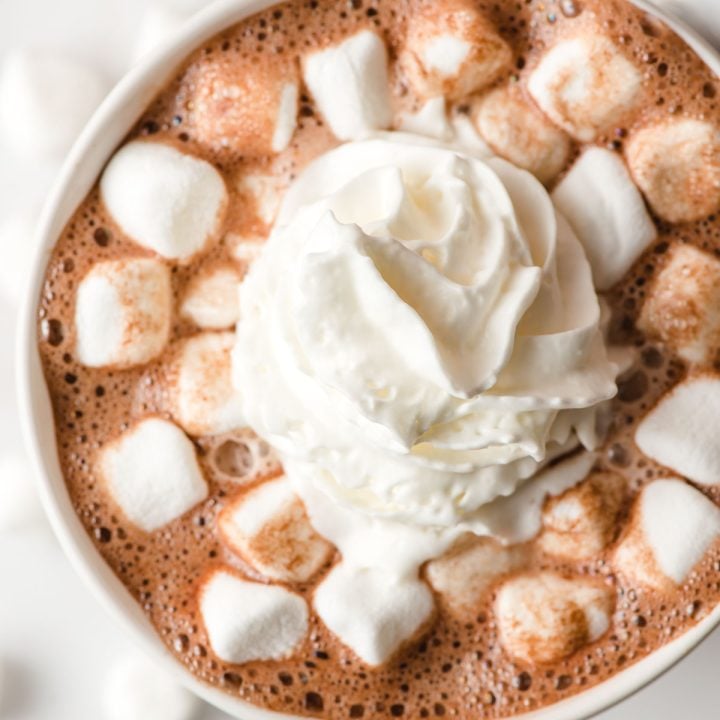 Top down image of hot chocote topped with whipped cream and marshmallows.
