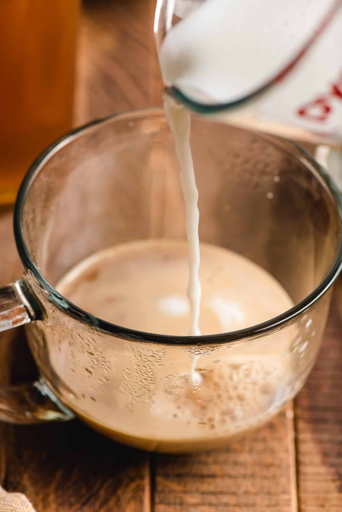 Steamed milk being poured into espresso.