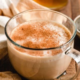 Mug of honey latte sprinkled with cinnamon.