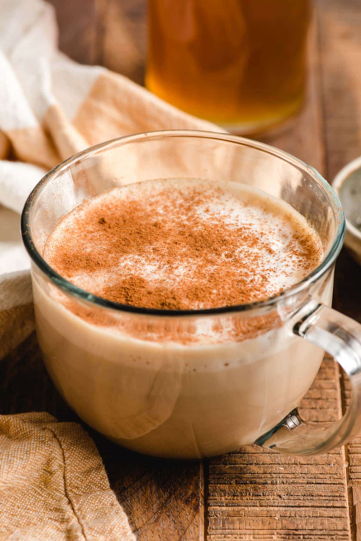 Mug of honey latte sprinkled with cinnamon.