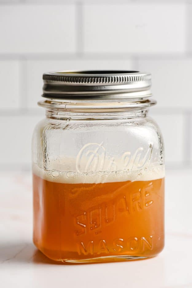 Honey simple syrup in a glass mason jar.