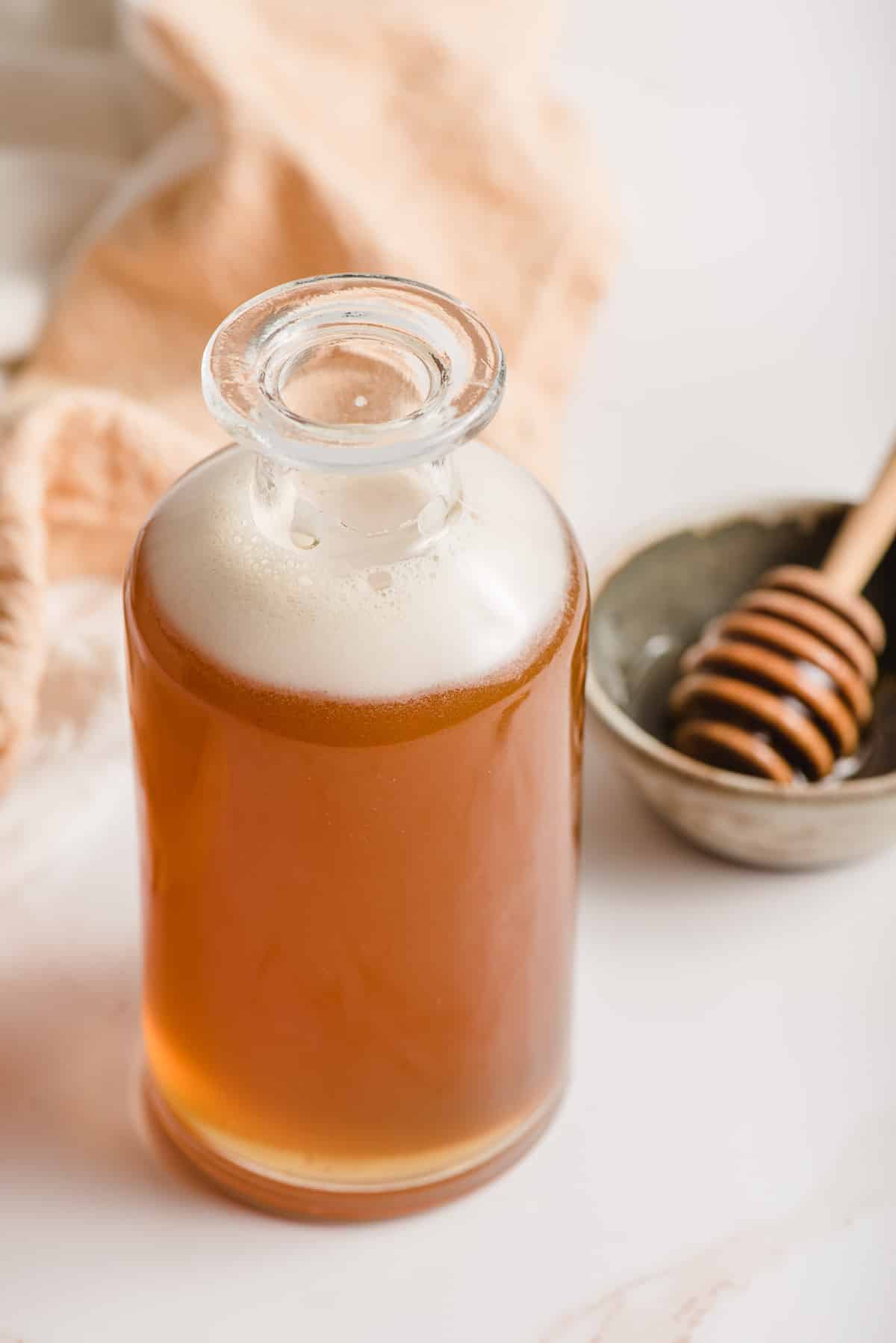Honey simple syrup in a glass container.