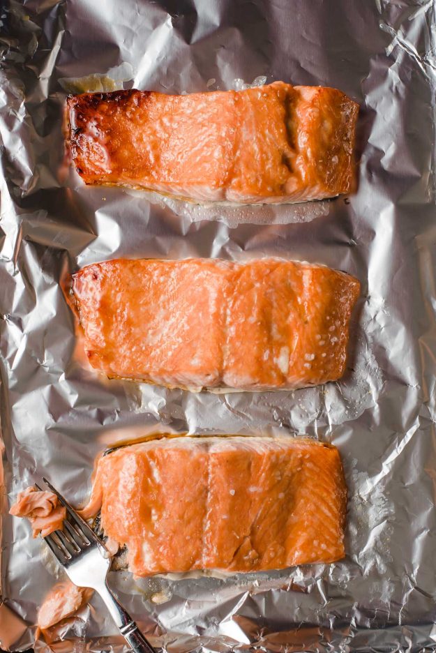 Salmon broiled with eel sauce on a foil lined sheet pan.