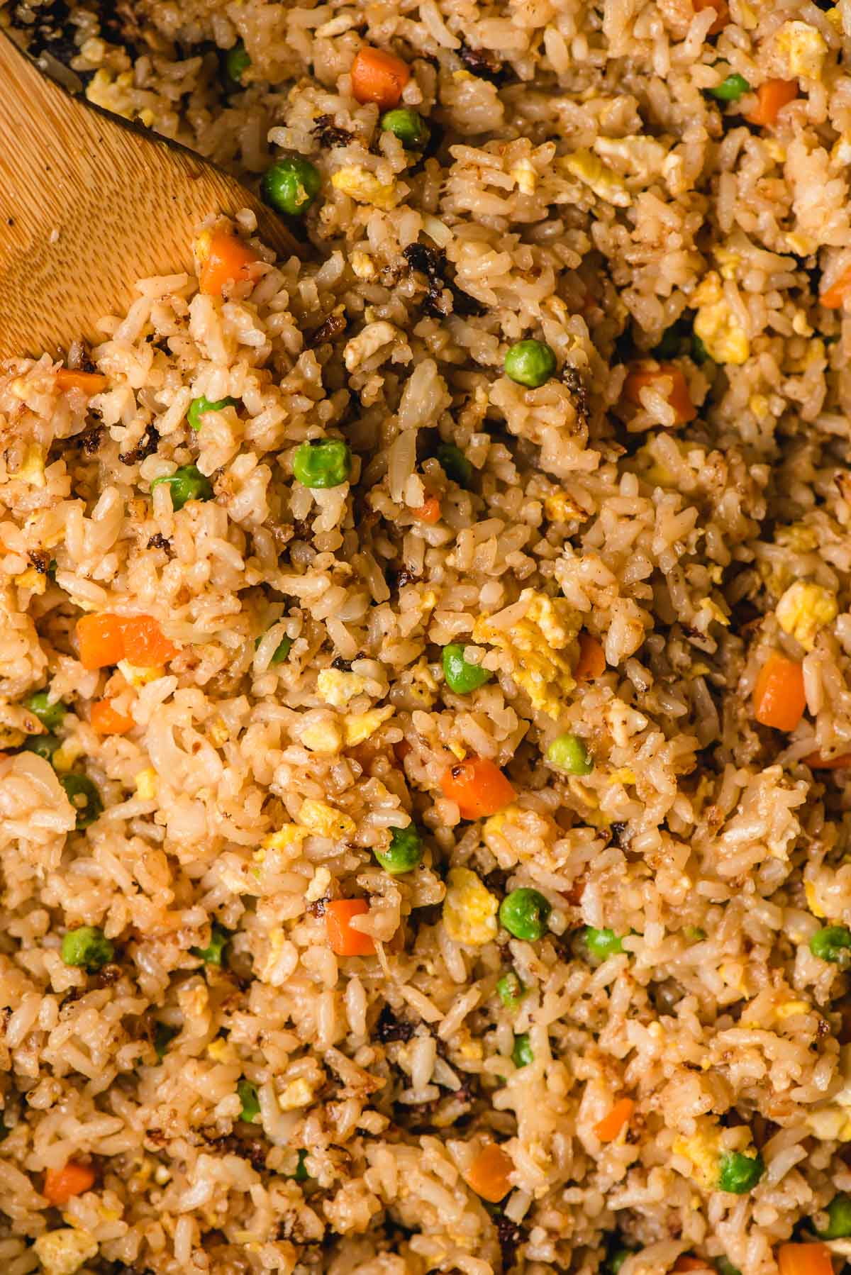 Close up image of hibachi fried rice with carrots and peas.