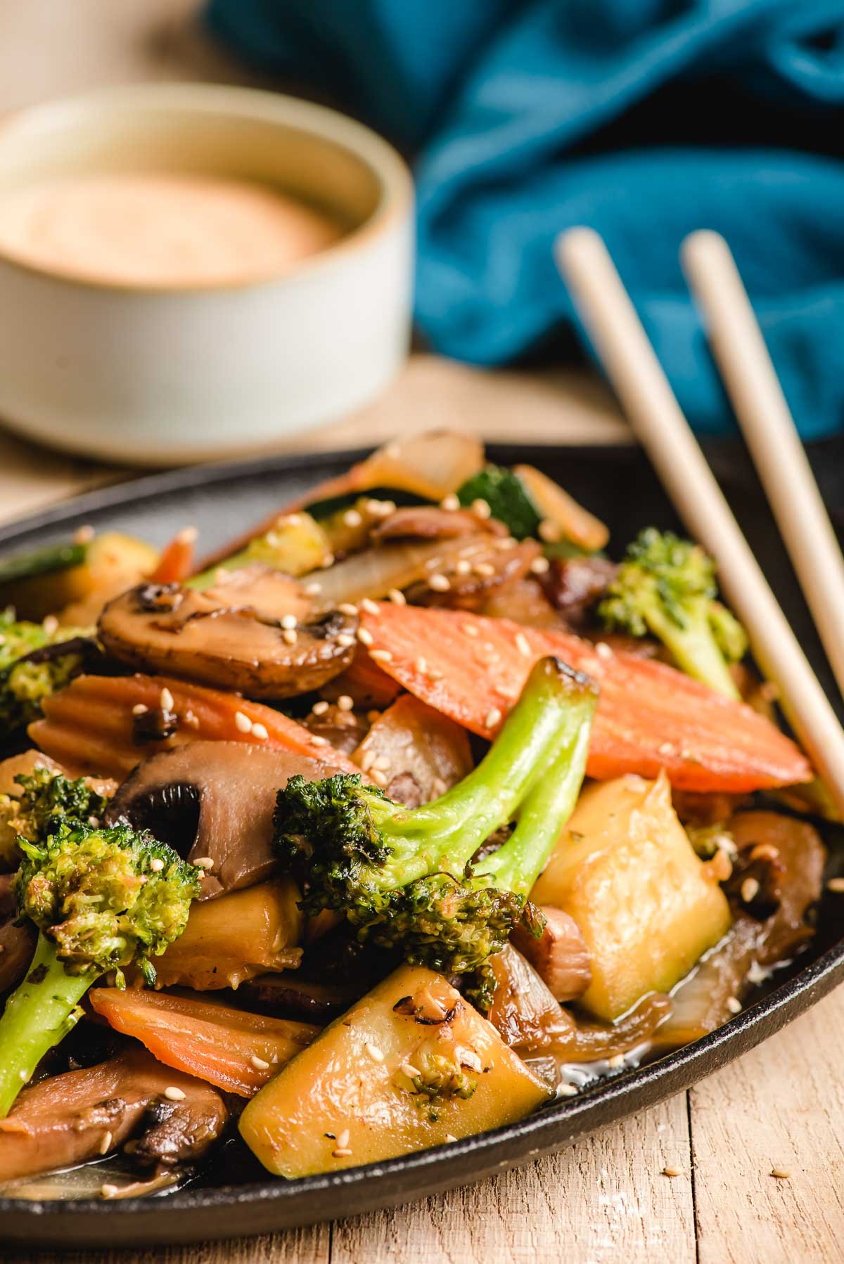 Hibachi vegetables on a plate with chopsticks.