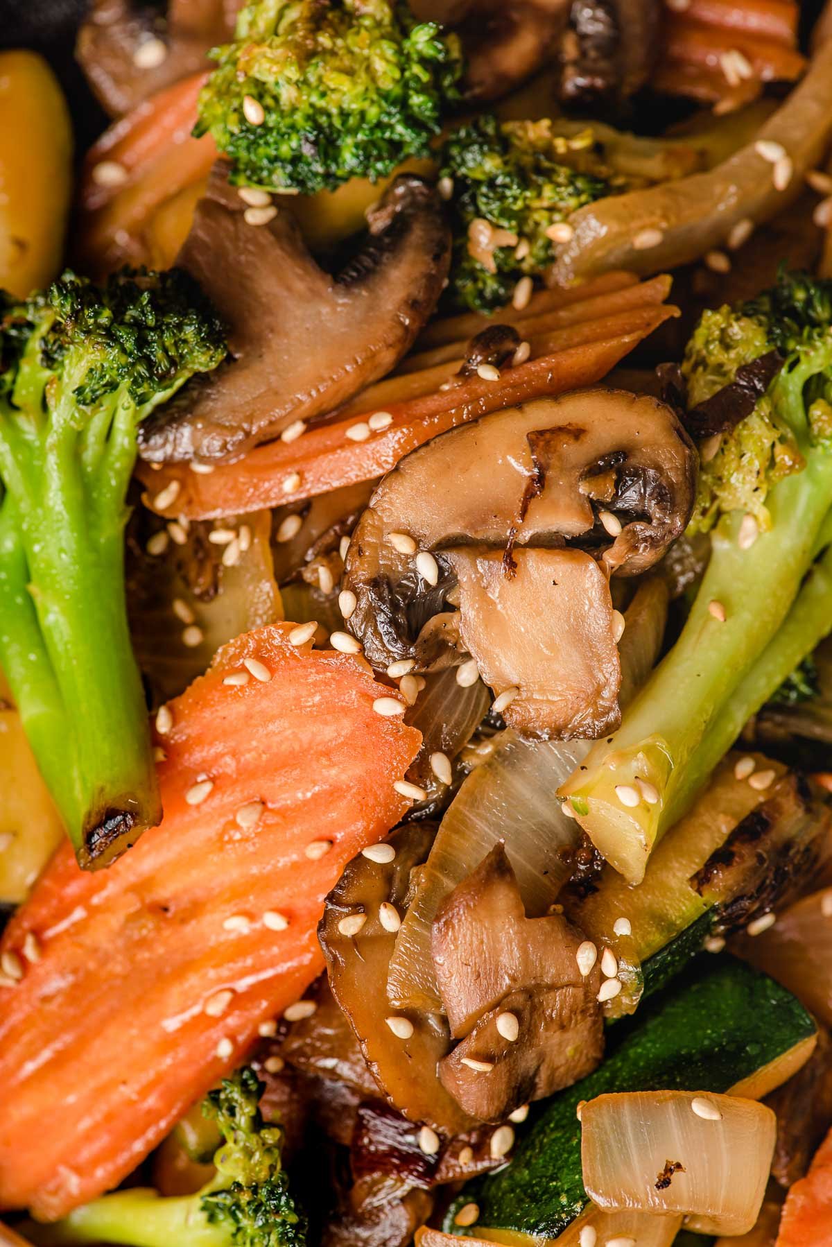 Hibachi veggies including mushroom, carrots, broccoli, onion and zucchini sprinkled with sesame seeds.