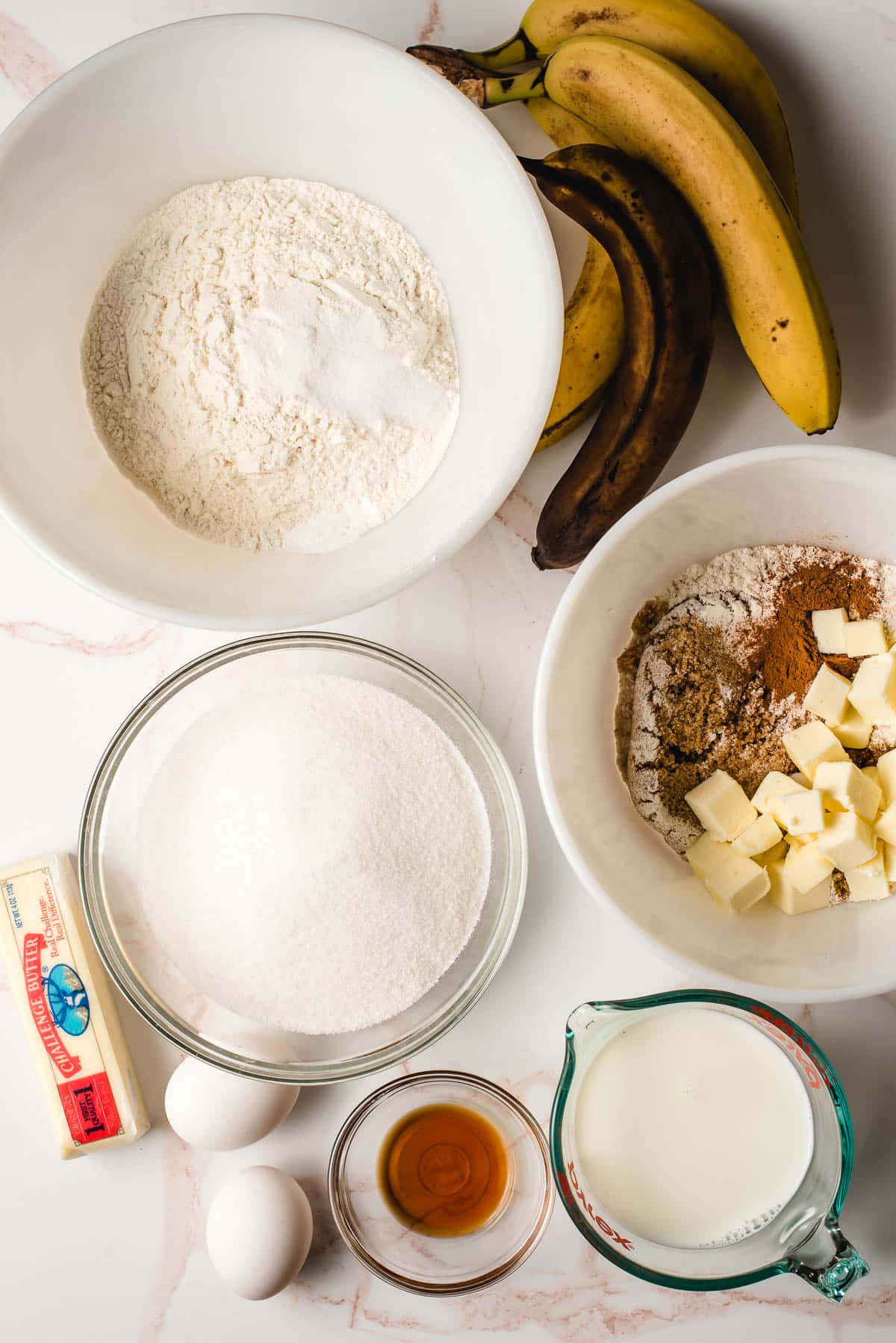 Ingredients for banana crumb cake displayed in various bowls.