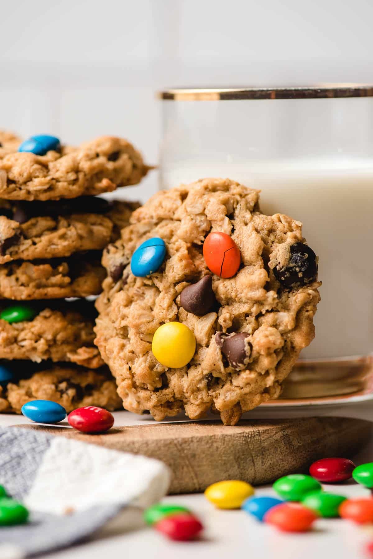 A stack of Gluten Self-ruling Monster Cookies with a glass of milk.