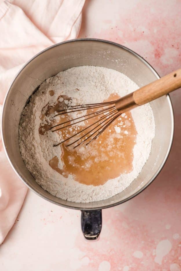 Vegetable oil being whisked into cake mix.