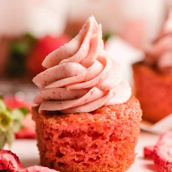 Strawberry cupcake with tall swirl of strawberry buttercream.