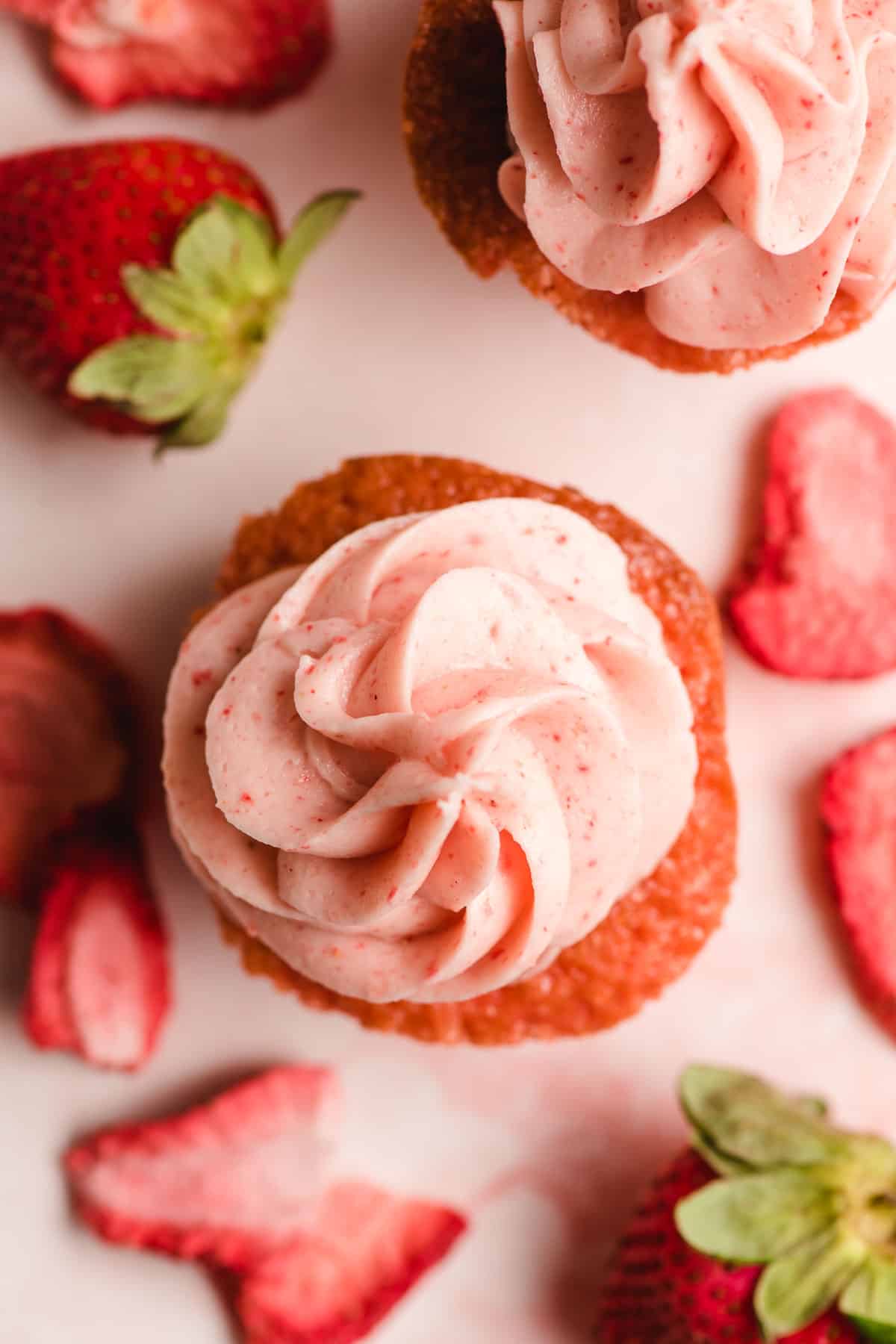 Top view of a strawberry cupcake with strawberry buttercream.