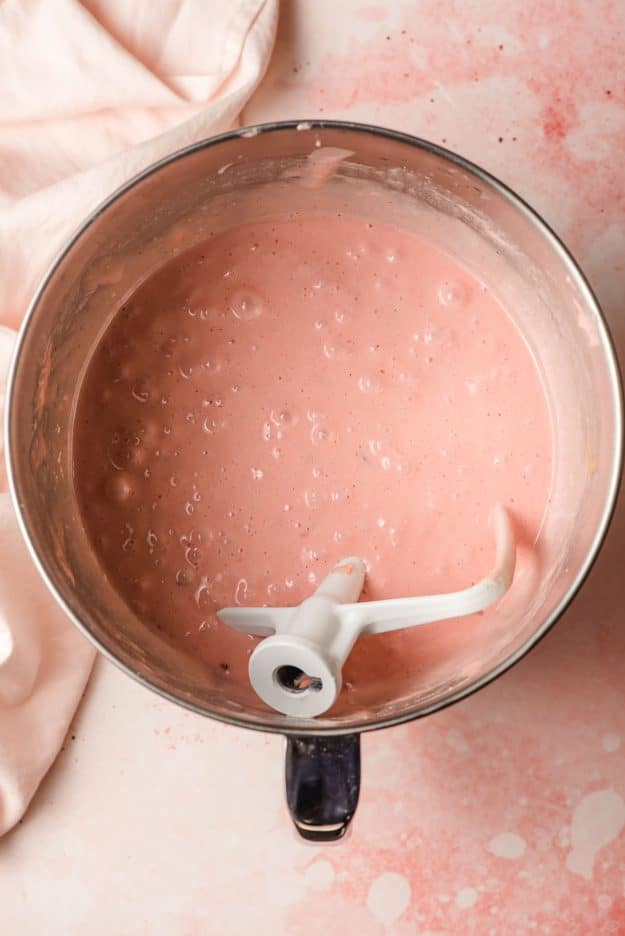 Strawberry cupcake thrash in the trencher of an electric mixer.