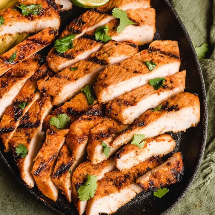 Spicy grilled turkey breast strips on a skillet.