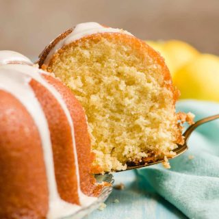 Slice of lemon bundt cake held by a pie server.