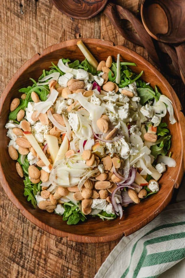 Marcona almonds, apples, shaved fennel, red onion slices, and goat cheese crumbles piled on a bed of mixed greens.