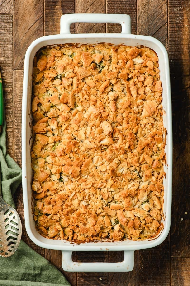 Freshly baked Broccoli cheese casserole with ritz cracker topping in a white casserole dish.