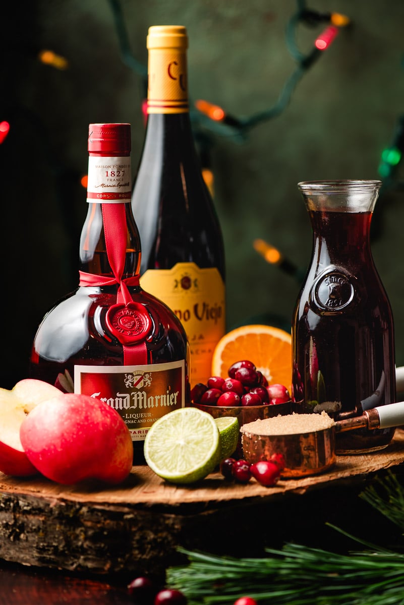 Grand Marnier, Campo Viejo red wine, and pomegranate juice surrounded by apples, limes, cranberries, and orange.