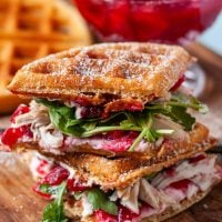 Two waffled cranberry turkey sandwiches stacked on top of each other.