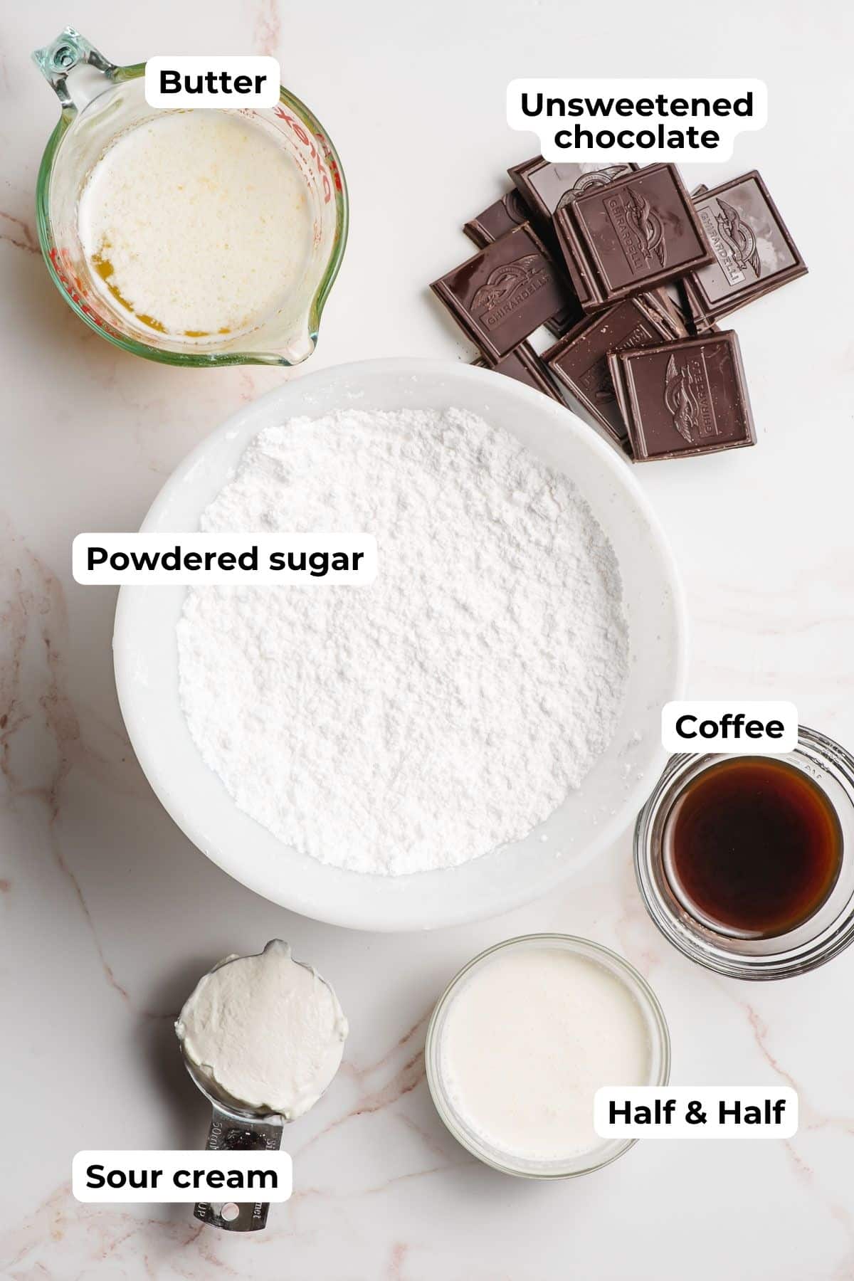 Melted butter, powdered sugar, unsweetened chocolate squares, sour cream, cream, and coffee in bowls.