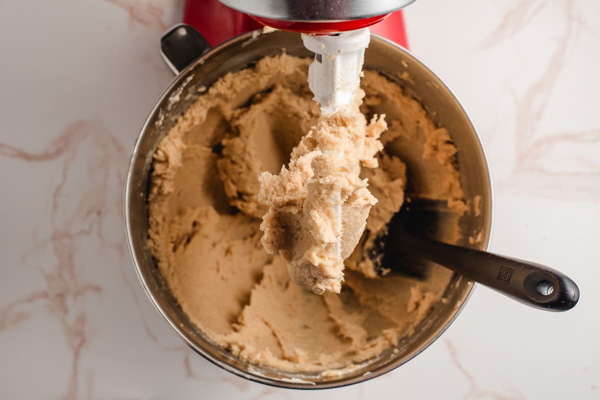Butter and sugars creamed together in the bowl of an electric mixer.