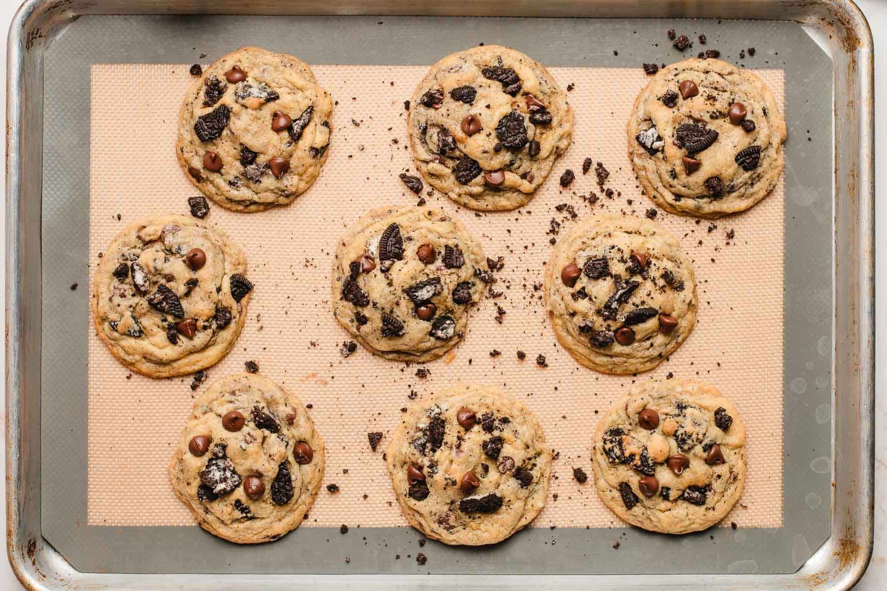 Freshly baked oreo chocolate chip cookies on a sheet pan.