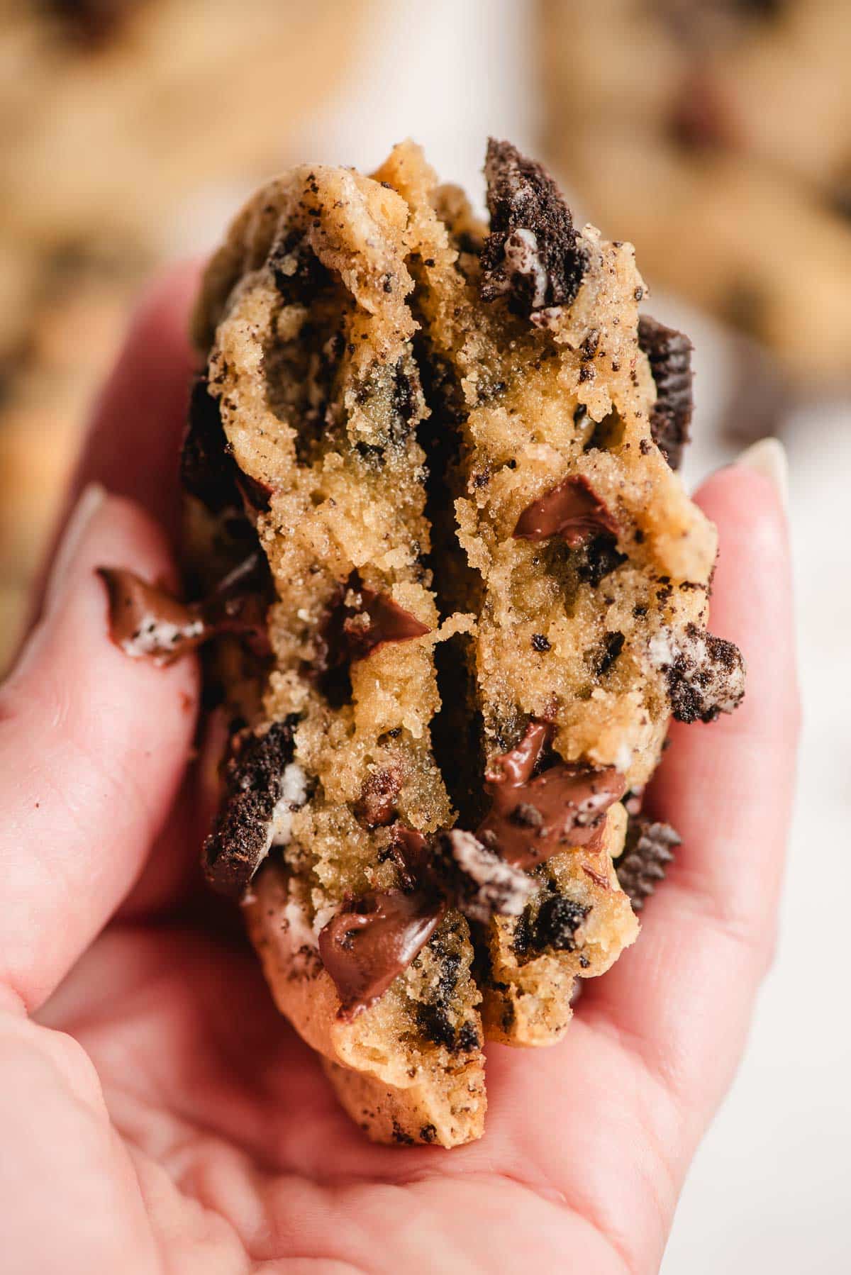 Oreo chocolate chip cookie split in half to show the melty chocolate inside.