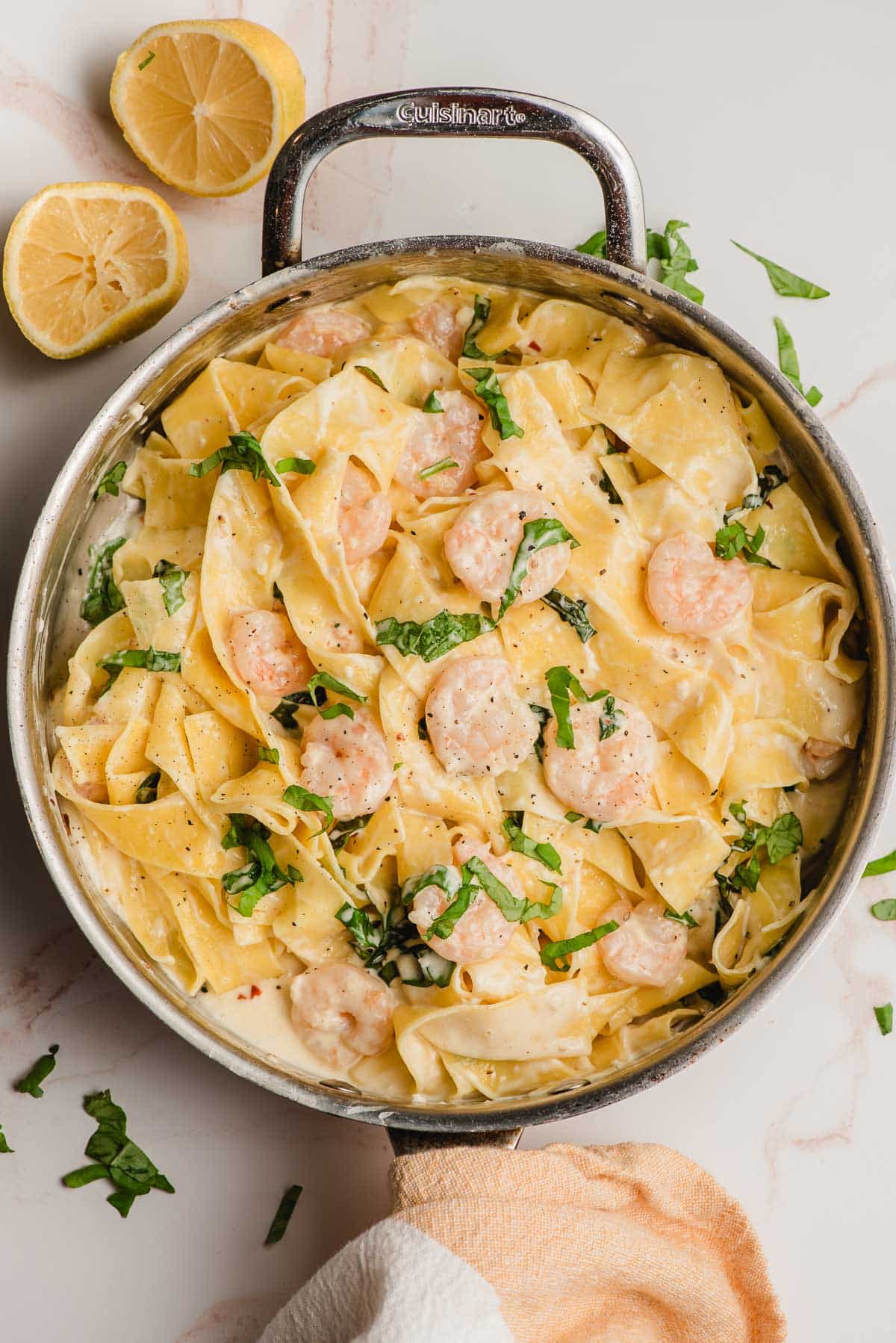 Shrimp Pappardelle with basil and cream in a large stainless steel skillet.