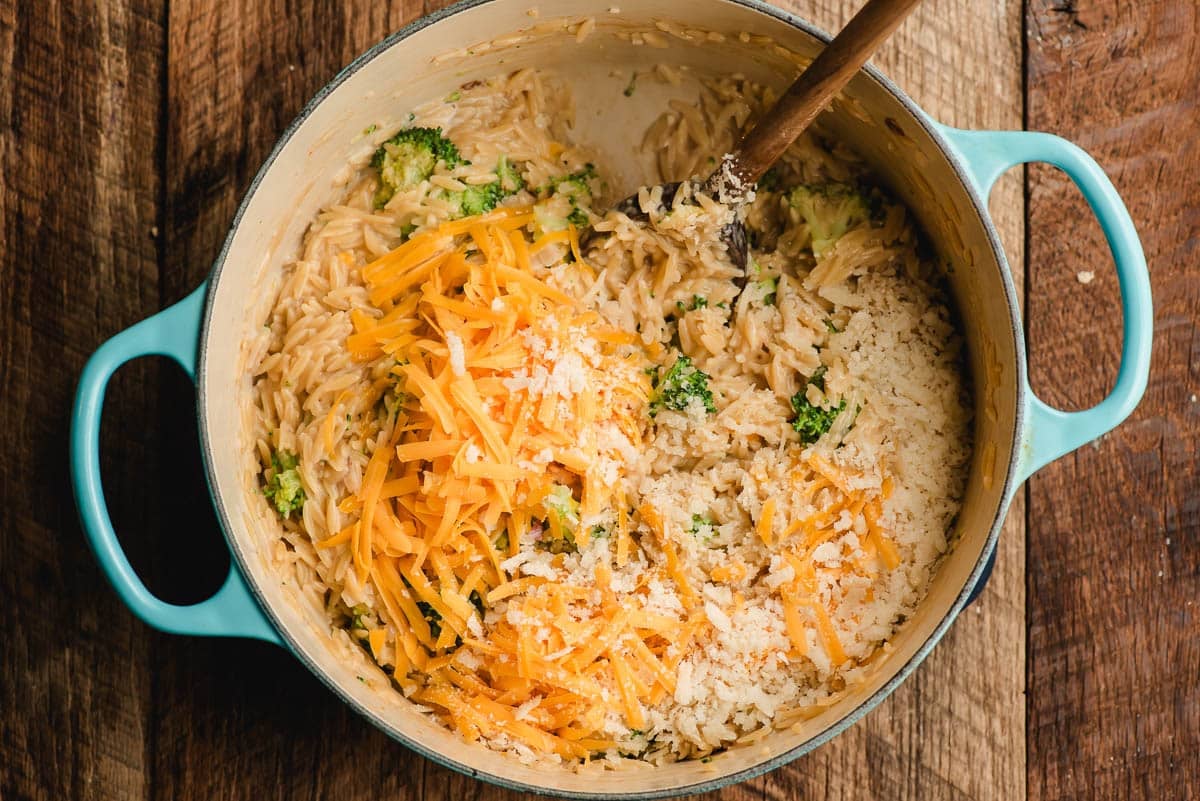 Shredded cheddar cheese and Parmesan stirred into broccoli orzo.