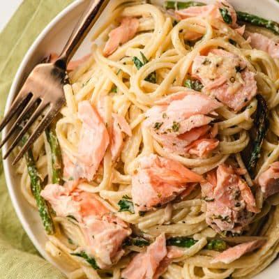 Creamy Salmon Linguine on a white plate with a gold fork.