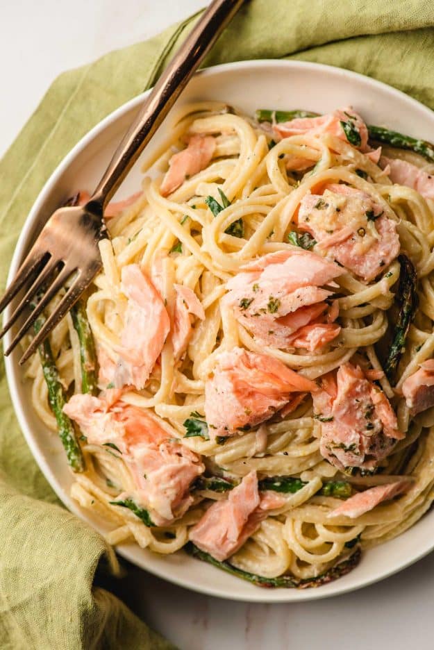 Creamy Salmon Linguine on a white plate with a gold fork.