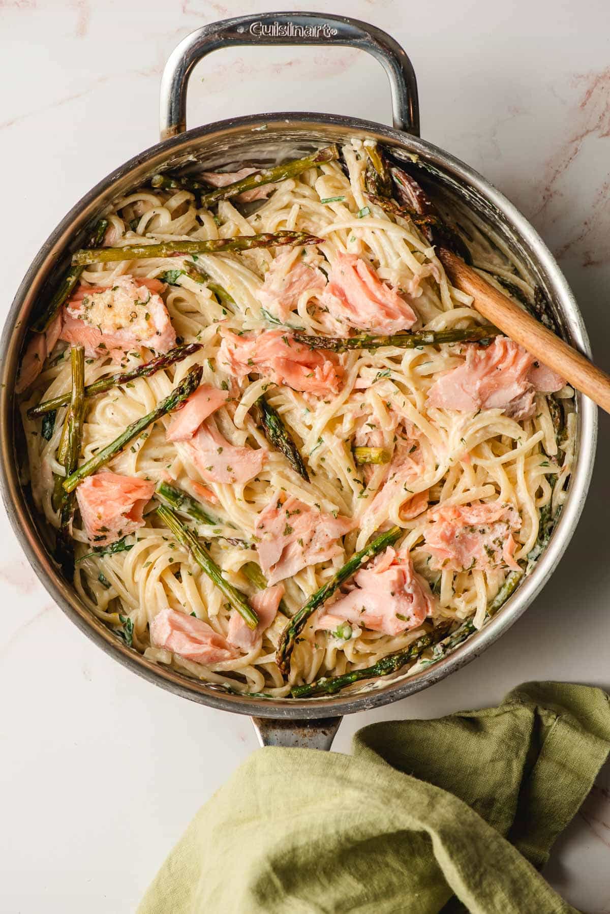 Creamy salmon and asparagus pasta in a skillet.