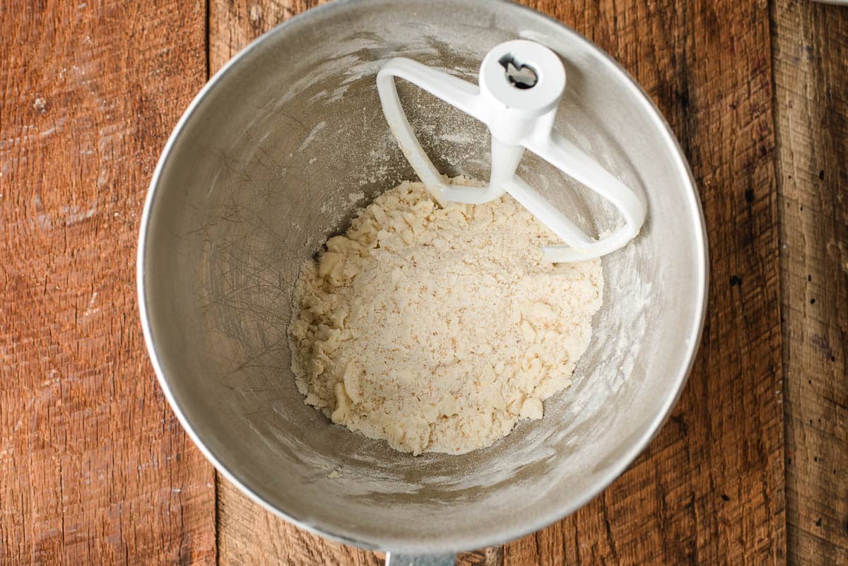 Crumb topping for pie in the bowl of an electric mixer.