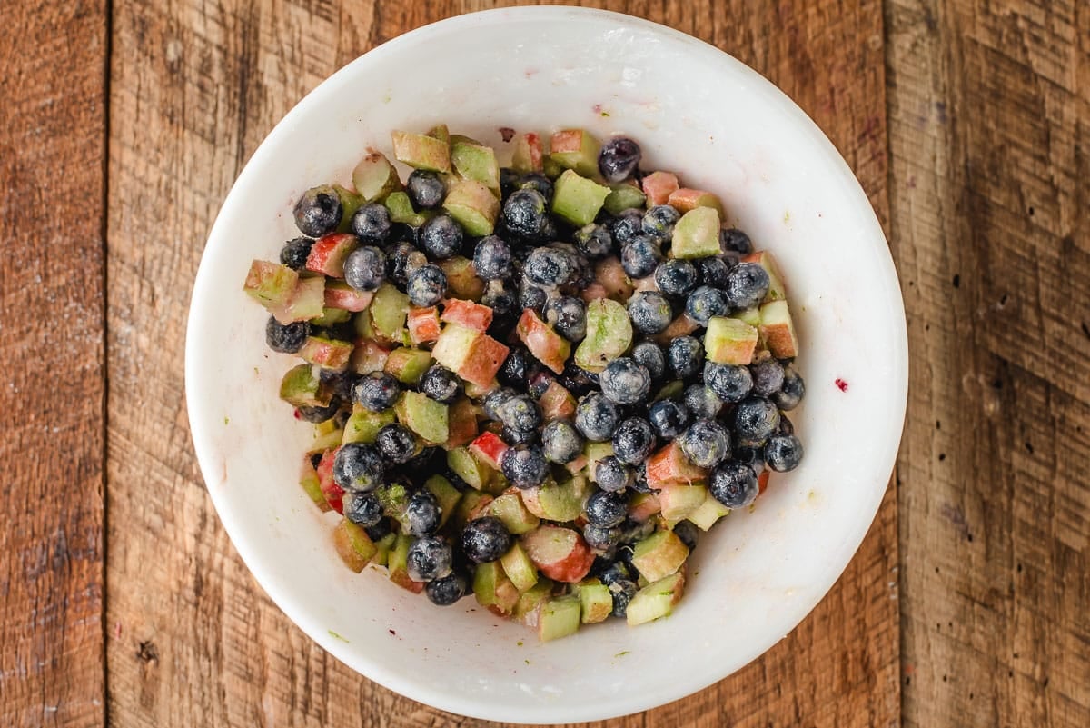 Blueberries and rhubarb tossed with sugar, lime zest, juice, cornstarch, and butter.
