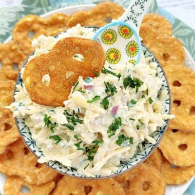 Jarlsfberg cheese dip with a pretzel crisp dipping in it.
