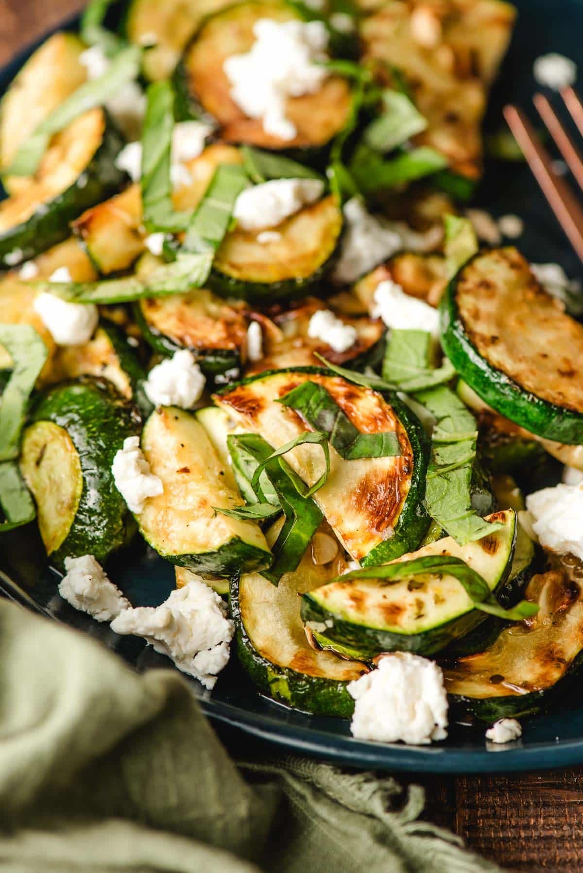 Zucchini side dish with goat cheese and fresh basil.