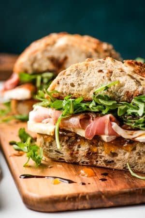 Brie sandwich with prosciutto and balsamic drizzle.