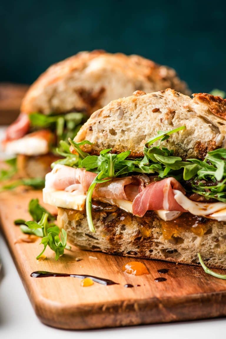 Brie sandwich with prosciutto and balsamic drizzle.