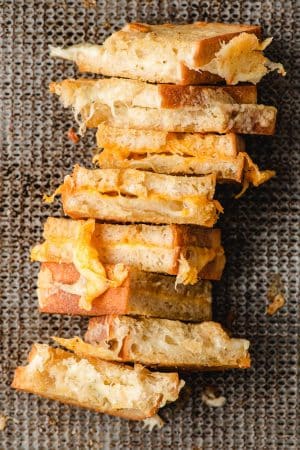 Oven baked grilled cheese arranged on a sheet pan.