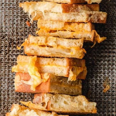 Oven baked grilled cheese arranged on a sheet pan.