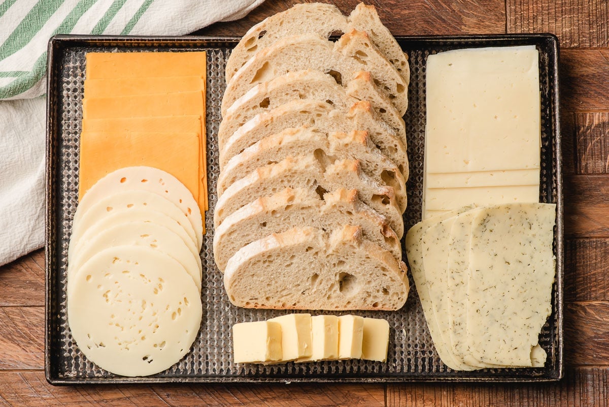 Sheet pan filled with bread, cheese, and butter.