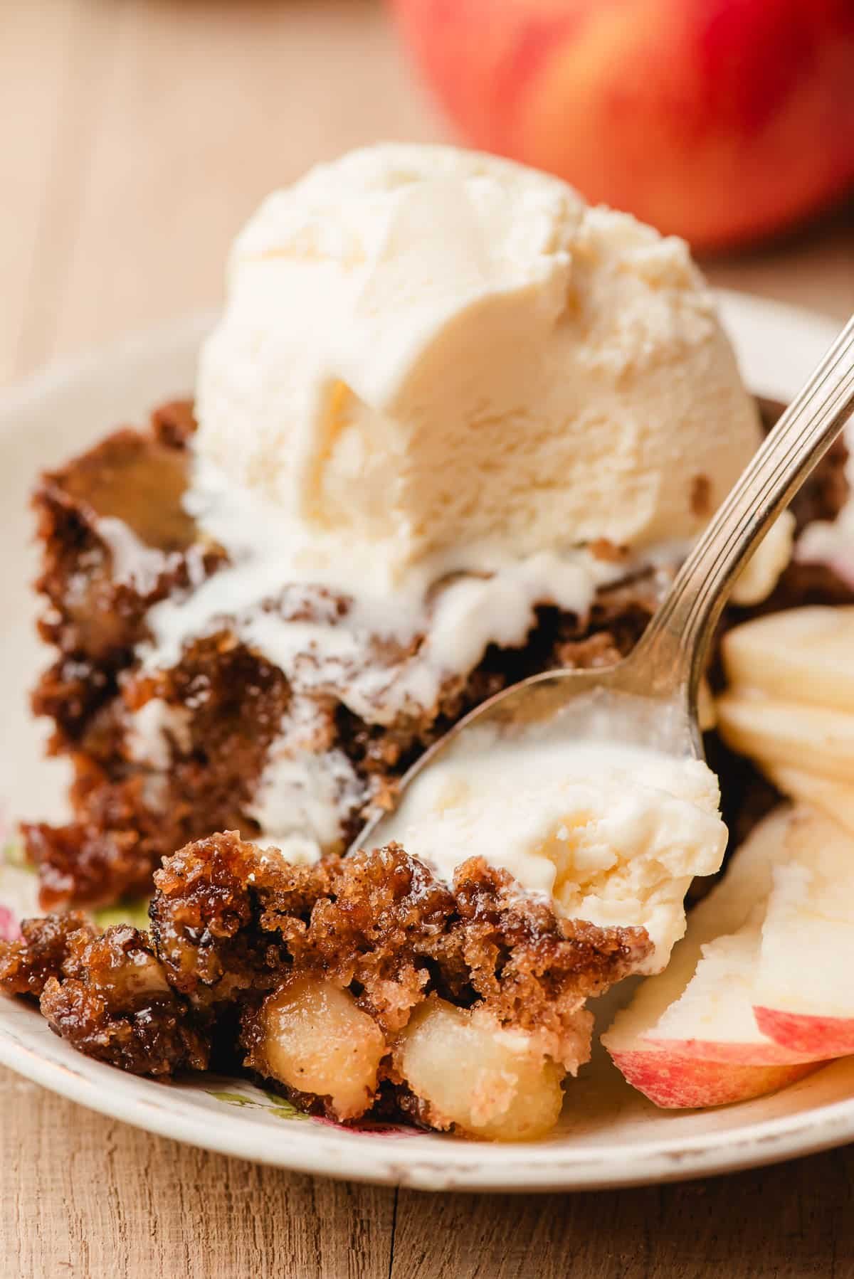 Spoon scooping up a bite of apple cake.