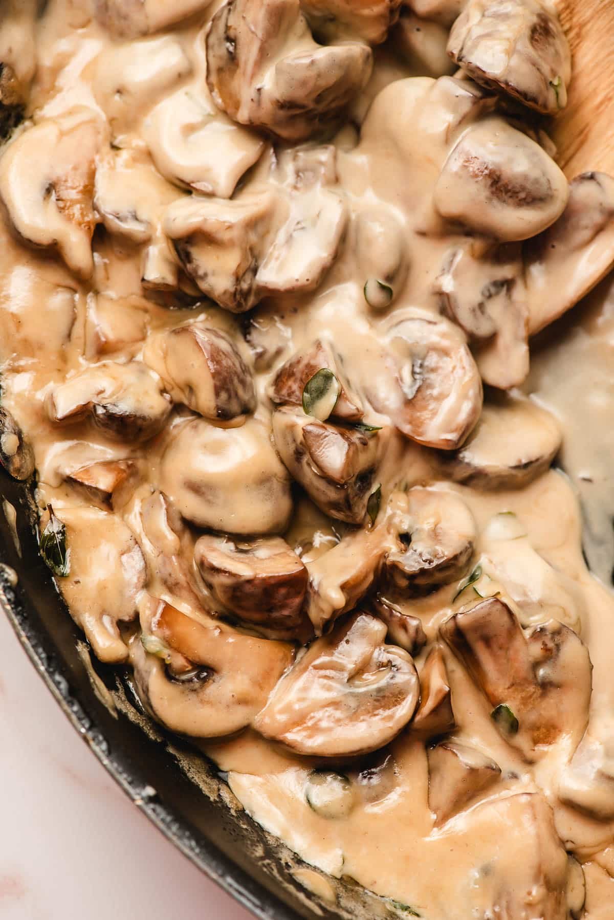 Mushrooms in cream sauce in a pan.
