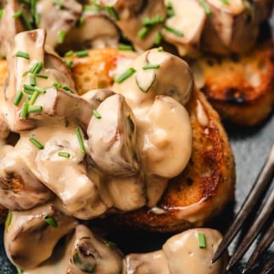 Creamy mushroom toast shown on a blue plate.
