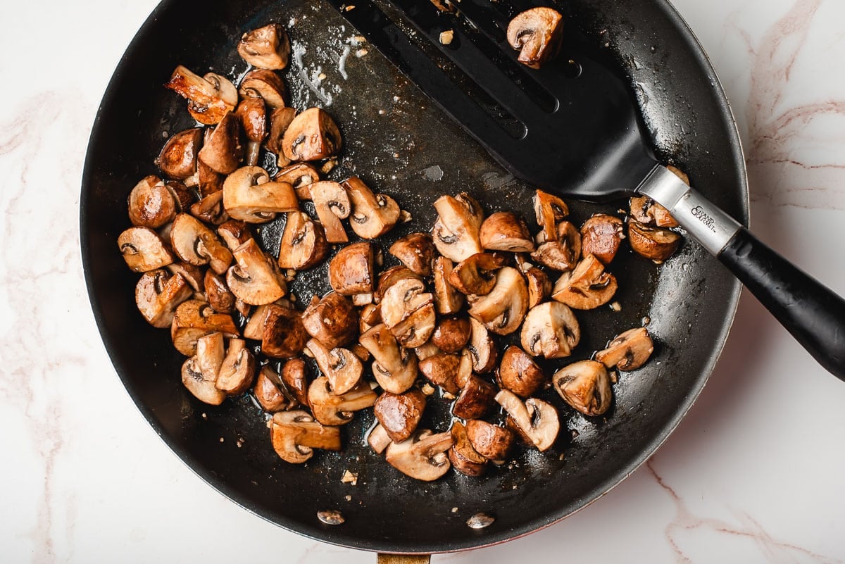 Sauteed mushrooms in a large skillet
