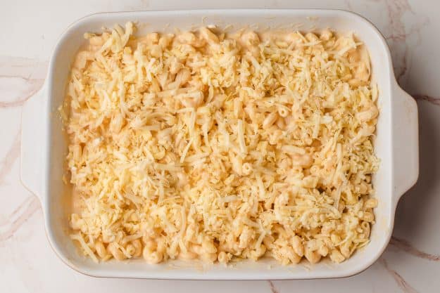 Creamy mac and cheese sprinkled with more cheeses, before going in the oven.