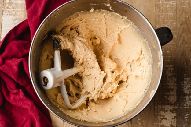 Eggs, vanilla, butter, and sugar beaten together in a bowl.